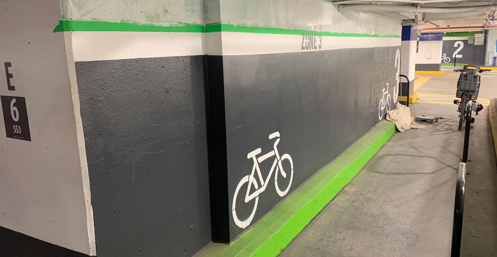 Dark garage wall with green bicycle lane detailing
